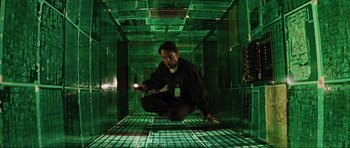 Movie still from “Event Horizon” (1997), directed by Paul W.S. Anderson – A man crouching down in a room with a flashlight; Wide shot, Overhead angle
