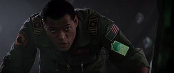 Movie still from “Event Horizon” (1997), directed by Paul W.S. Anderson – A man in military fatigues is looking at the camera; Close Up shot, Low angle