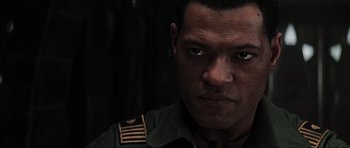 Movie still from “Event Horizon” (1997), directed by Paul W.S. Anderson – A person wearing a military uniform; Close Up shot, Over the shoulder angle