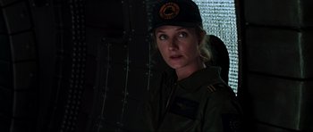 Movie still from “Event Horizon” (1997), directed by Paul W.S. Anderson – A woman in a uniform looking into the distance; Close Up shot, Over the shoulder angle