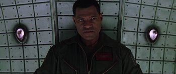 Movie still from “Event Horizon” (1997), directed by Paul W.S. Anderson – A person wearing a uniform; Close Up shot, Low angle