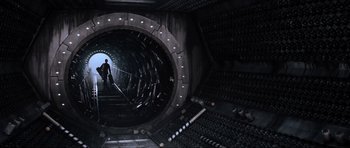 Movie still from “Event Horizon” (1997), directed by Paul W.S. Anderson – A man is walking through a tunnel with lights on it; Wide shot, Overhead angle