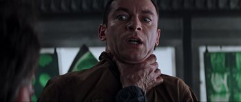 Movie still from “Event Horizon” (1997), directed by Paul W.S. Anderson – A person holding his neck; Close Up shot, Low angle