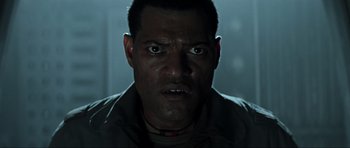 Movie still from “Event Horizon” (1997), directed by Paul W.S. Anderson – A person staring at the camera; Close Up shot, Low angle