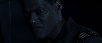 Movie still from “Event Horizon” (1997), directed by Paul W.S. Anderson – A man's face in the dark; Close Up shot, High angle