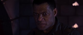 Movie still from “Event Horizon” (1997), directed by Paul W.S. Anderson – A man's face in the dark; Close Up shot, Low angle