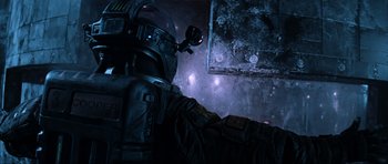 Movie still from “Event Horizon” (1997), directed by Paul W.S. Anderson – A person in a space suit looking into a window; Close Up shot, Low angle