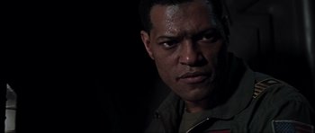 Movie still from “Event Horizon” (1997), directed by Paul W.S. Anderson – A man's face in the dark; Close Up shot, Over the shoulder angle