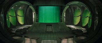 Movie still from “Event Horizon” (1997), directed by Paul W.S. Anderson – An empty room with a green screen in the center of the room; Extreme Wide shot, High angle