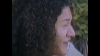 Movie still from “Every Body” (2023), directed by Julie Cohen – A person with curly black hair; Extreme Close Up shot, High angle