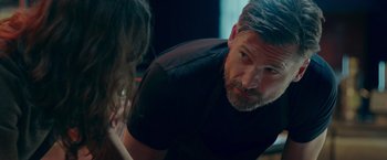 Movie still from “A Taste of Hunger” (2021), directed by Christoffer Boe – A person sitting in a room; Medium shot, Over the shoulder angle