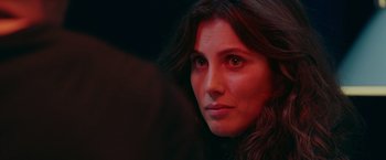 Movie still from “A Taste of Hunger” (2021), directed by Christoffer Boe – A woman's face in a red light; Close Up shot, Over the shoulder angle