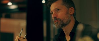 Movie still from “A Taste of Hunger” (2021), directed by Christoffer Boe – A person wearing a black shirt; Close Up shot, Over the shoulder angle