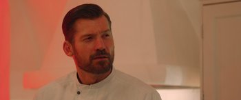 Movie still from “A Taste of Hunger” (2021), directed by Christoffer Boe – A person wearing a white shirt; Close Up shot, Low angle