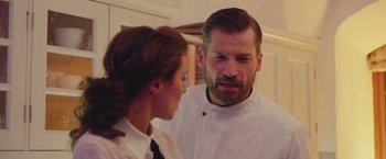 Movie still from “A Taste of Hunger” (2021), directed by Christoffer Boe – A man and a woman are looking at each other; Close Up shot, Over the shoulder angle