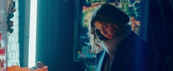 Movie still from “A Taste of Hunger” (2021), directed by Christoffer Boe – A young woman is looking down at her face; Medium shot, Low angle