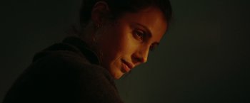 Movie still from “A Taste of Hunger” (2021), directed by Christoffer Boe – A woman's face in the dark; Close Up shot, Low angle