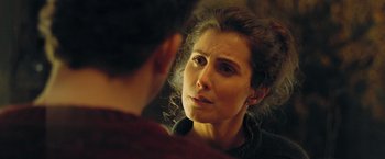 Movie still from “A Taste of Hunger” (2021), directed by Christoffer Boe – A woman looking in the mirror while talking to another woman; Close Up shot, Over the shoulder angle