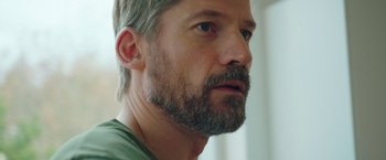 Movie still from “A Taste of Hunger” (2021), directed by Christoffer Boe – A person with a beard; Close Up shot, Over the shoulder angle