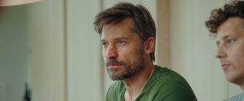 Movie still from “A Taste of Hunger” (2021), directed by Christoffer Boe – A person wearing a green shirt; Close Up shot, Low angle