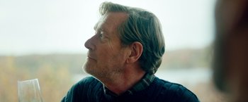 Movie still from “A Taste of Hunger” (2021), directed by Christoffer Boe – An older man wearing a sweater looking to his left; Close Up shot, Low angle