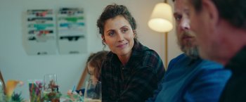 Movie still from “A Taste of Hunger” (2021), directed by Christoffer Boe – A person sitting at a table with a glass; Close Up shot, Over the shoulder angle