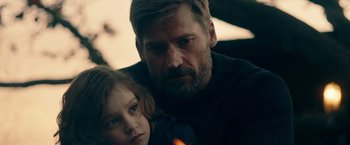 Movie still from “A Taste of Hunger” (2021), directed by Christoffer Boe – A man and a little girl are looking at the camera; Close Up shot, Over the shoulder angle