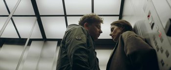 Movie still from “A Taste of Hunger” (2021), directed by Christoffer Boe – A man and a woman standing next to each other; Medium shot, Low angle