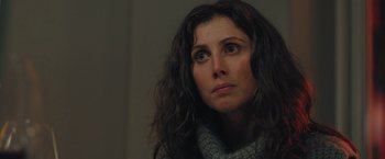 Movie still from “A Taste of Hunger” (2021), directed by Christoffer Boe – A person with long dark hair; Close Up shot, Over the shoulder angle