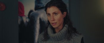 Movie still from “A Taste of Hunger” (2021), directed by Christoffer Boe – A person wearing a sweater; Close Up shot, Over the shoulder angle
