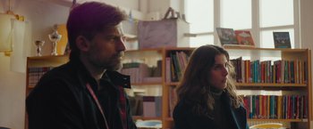 Movie still from “A Taste of Hunger” (2021), directed by Christoffer Boe – A man and a woman standing next to each other in a room; Medium shot, Over the shoulder angle