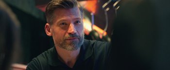 Movie still from “A Taste of Hunger” (2021), directed by Christoffer Boe – A person wearing a black shirt; Close Up shot, Over the shoulder angle