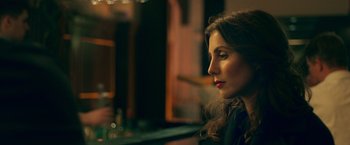 Movie still from “A Taste of Hunger” (2021), directed by Christoffer Boe – A person sitting at a table; Close Up shot, Over the shoulder angle