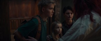 A group of people standing next to each other in a room