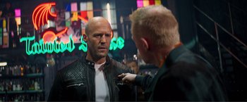 Movie still from “Expend4bles” (2023), directed by Scott Waugh – A man talking to another man wearing a leather jacket; Close Up shot, Over the shoulder angle