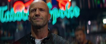 Movie still from “Expend4bles” (2023), directed by Scott Waugh – A man with a shaved head wearing a leather jacket; Close Up shot, Low angle