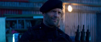 Movie still from “Expend4bles” (2023), directed by Scott Waugh – A person wearing a uniform; Close Up shot, Over the shoulder angle