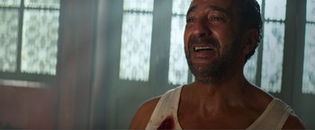 Movie still from “Expend4bles” (2023), directed by Scott Waugh – A person with a wound on his face; Close Up shot, High angle