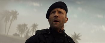 Movie still from “Expend4bles” (2023), directed by Scott Waugh – A person wearing a hat; Close Up shot, Low angle