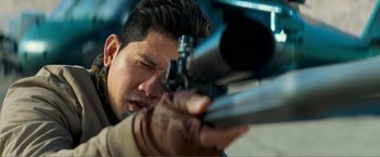 Movie still from “Expend4bles” (2023), directed by Scott Waugh – A person with a rifle; Extreme Close Up shot, Low angle