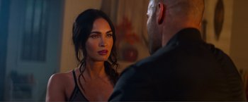 Movie still from “Expend4bles” (2023), directed by Scott Waugh – A man and a woman are looking at one another; Close Up shot, Over the shoulder angle