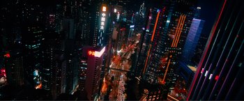Movie still from “Expend4bles” (2023), directed by Scott Waugh – An aerial view of a busy city at night time; Extreme Wide shot, High angle