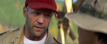 Movie still from “Expend4bles” (2023), directed by Scott Waugh – A person wearing a hat; Close Up shot, Low angle