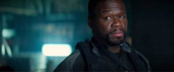 Movie still from “Expend4bles” (2023), directed by Scott Waugh – A person wearing a jacket; Close Up shot, Over the shoulder angle