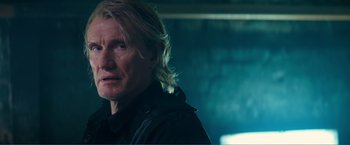 Movie still from “Expend4bles” (2023), directed by Scott Waugh – A person with long hair; Close Up shot, Low angle