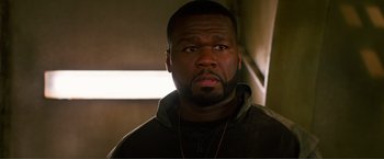 Movie still from “Expend4bles” (2023), directed by Scott Waugh – A person wearing a jacket; Close Up shot, Over the shoulder angle