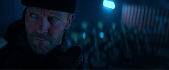 Movie still from “Expend4bles” (2023), directed by Scott Waugh – A person wearing a hat; Close Up shot, Over the shoulder angle