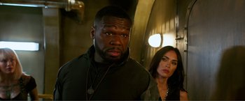 Movie still from “Expend4bles” (2023), directed by Scott Waugh – A man and a woman standing next to each other; Close Up shot, Over the shoulder angle