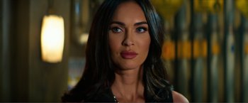 Movie still from “Expend4bles” (2023), directed by Scott Waugh – A person with long black hair; Close Up shot, Over the shoulder angle