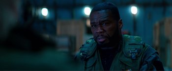 Movie still from “Expend4bles” (2023), directed by Scott Waugh – A person wearing a jacket; Close Up shot, Over the shoulder angle